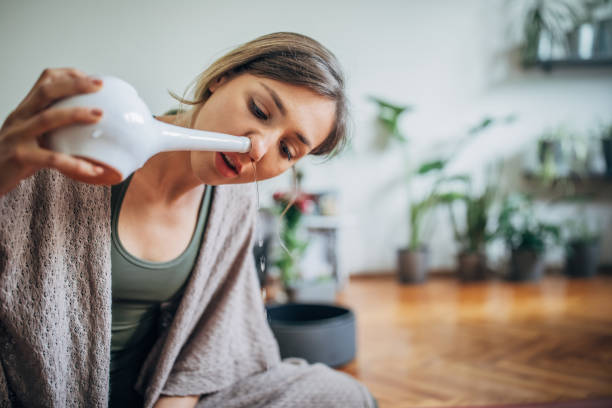 istock Beautiful woman using neti pot 1240137946