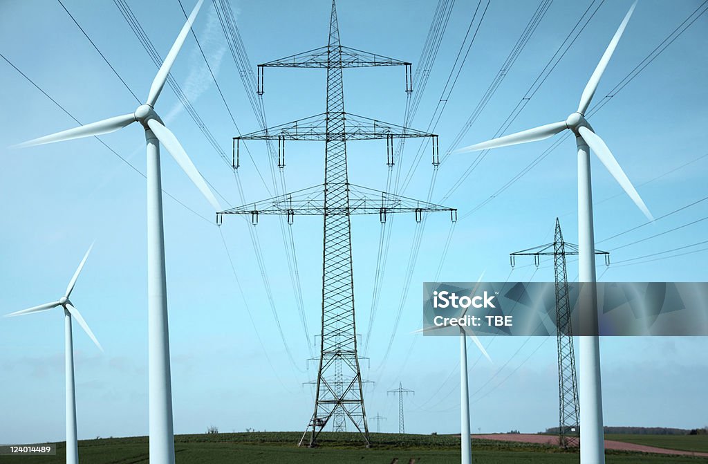 Clean Tech Illustration of the wind of change in energy policy - wind power stations combined with electrical transmission towers Solar Energy Stock Photo