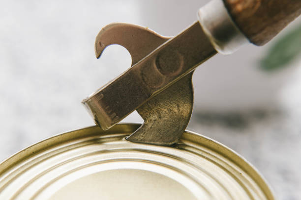 istock close-up opening canned tins with a corkscrew 1240163540