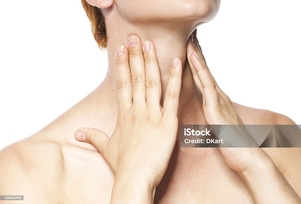 Acute pain in a throat at the young women. Acute pain in a throat at the young women. young girl keeps for a sick throat on a white background Adult Stock Photo