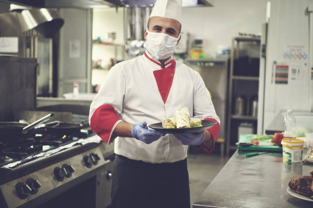 istock chef cook wearing face protective medical mask for protection from coronavirus 1240174232