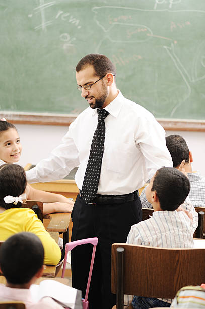 Education activities in classroom at school, children with teacher stock photo