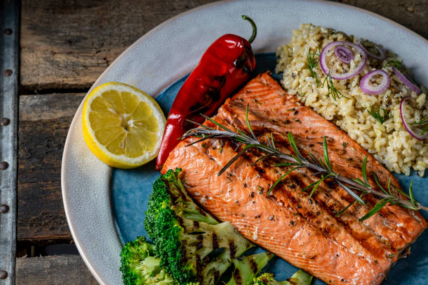 istock Grilled Salmon on a serving plate with rice and grilled broccoli. 1240188081