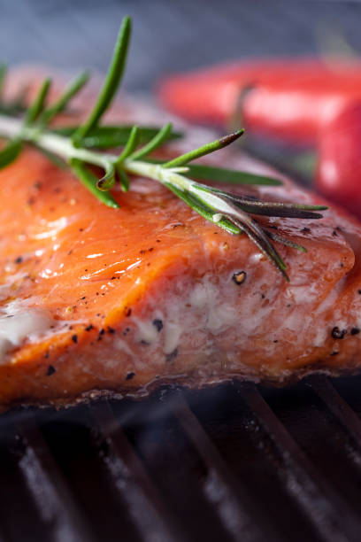 istock Salmon cooking on a grill. 1240188501