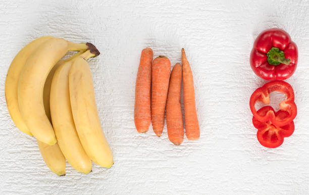 bananas, carrots and sweet peppers, lie on a white background