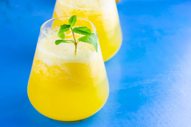 istock Pineapple cocktail on a blue background. Cold pineapple cocktail with mint. Summer tropical cocktail. Healthy drink. Copy space 1240204918
