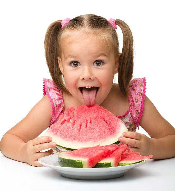 Cute little girl is going to eat watermelon stock photo