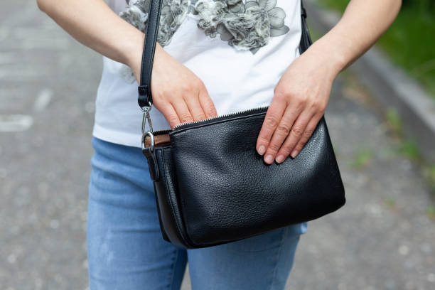 istock woman open bag in street 1240211486