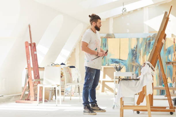 istock Male Artist in Spacious Art Studio 1240227611