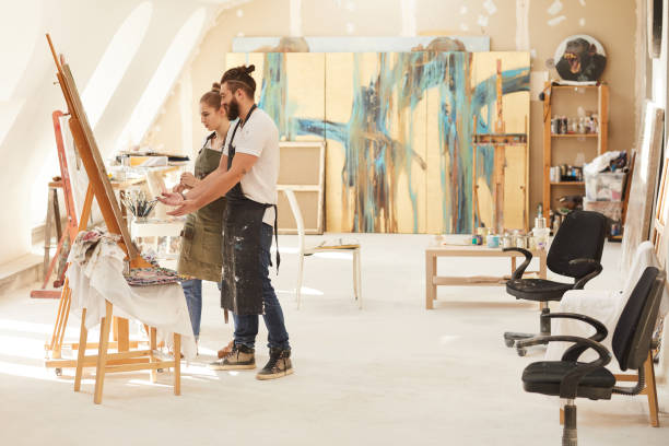 istock Creative Couple Painting in Art Studio 1240227688