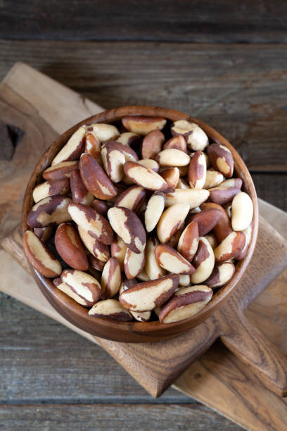 istock Brazil nuts in round bowl on wooden boards 1240232021