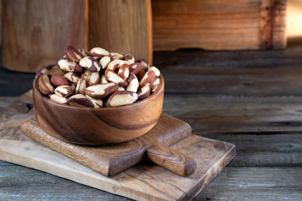 istock Brazil nuts in round bowl on wooden boards 1240232592