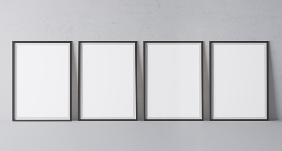 Four black vertical frames mock up. Frame poster size A4, A3 standing on gray floor. Stock photo