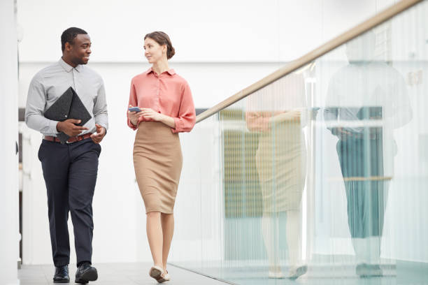 istock Two Business People Walking in Office Building 1240233602