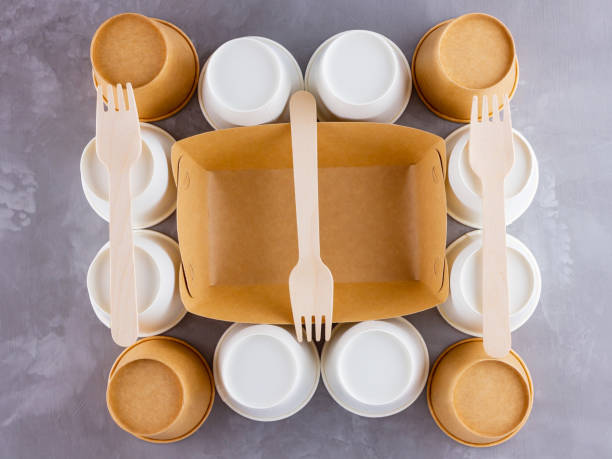 istock Zero waste. Disposable tableware. Eco-friendly disposable utensils made of bamboo wood and paper on a gray background. Paper cups, fast food containers and bamboo wooden cutlery 1240238535