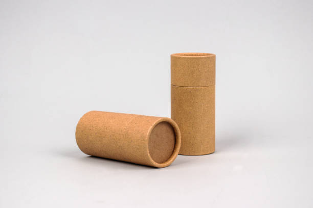 istock Paper tubes on grey background with copyspace - cardboard packaging for natural cosmetics and deodorant. Reusable packaging and recycling concept. Mockup 1240239173