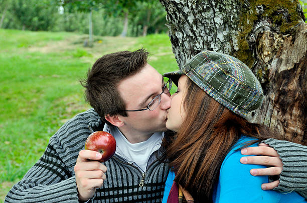 istock Apple Picking Couple Kiss Under Tree 124024008