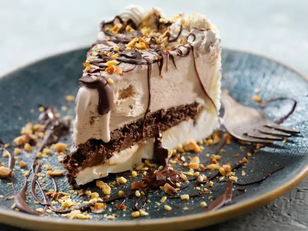 Photo of Cookie Dough Ice Cream Cake with Chocolate Sauce and Crushed Almonds