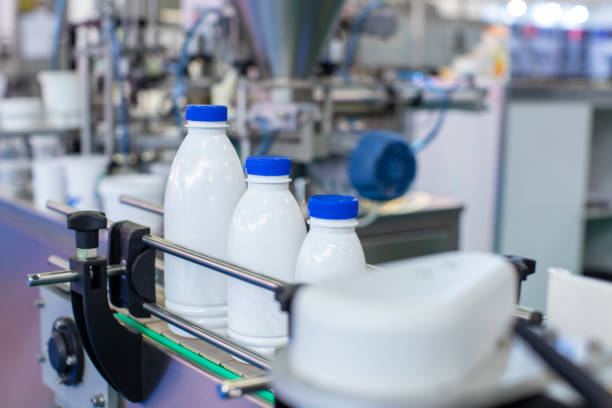 factory line for bottling milk or yogurt - milk industry milk bottle factory imagens e fotografias de stock