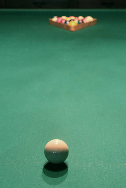 istock Abstract shot of colored billiard balls on green felt pool table with triangle 1240261191