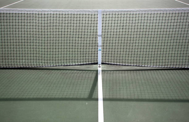 istock Various angles of green tennis courts with white stripes and nets 1240261744