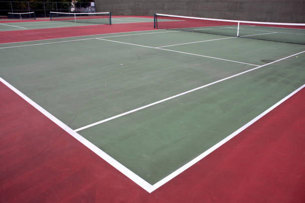 istock Various angles of green tennis courts with white stripes and nets 1240262831
