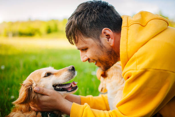 istock Young Man Having Fun With His Dogs 1240305591