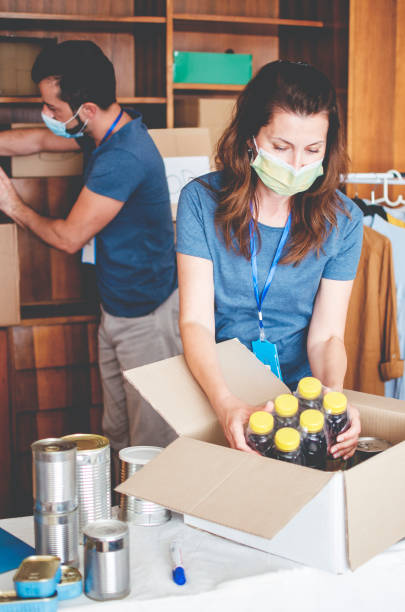 istock Take care of packing donation box with humanitarian aid 1240306119