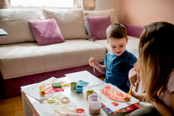 istock Cute little boy coloring with water colors 1240307760