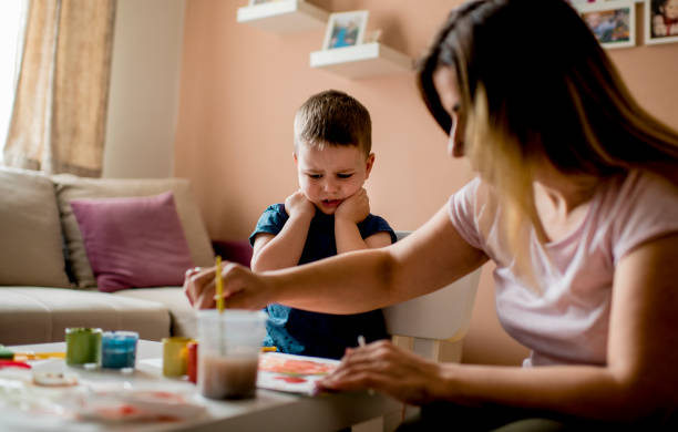 istock Cute little boy coloring with water colors 1240310439