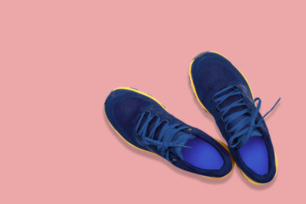 istock blue sneakers on a pink background 1240315316