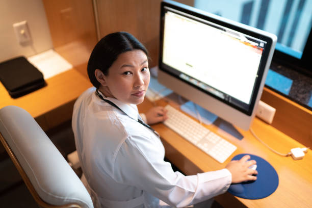 istock Portrait of female doctor using desktop pc at doctor's office 1240316972