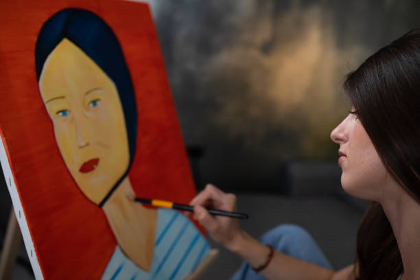 istock A pretty female painter painting at her home 1240330511