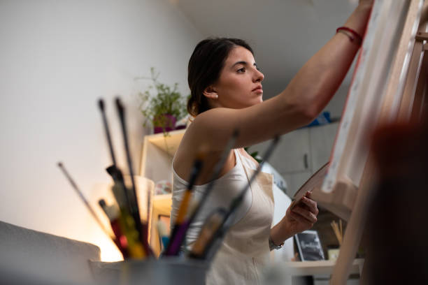 istock A young woman painting 1240331067