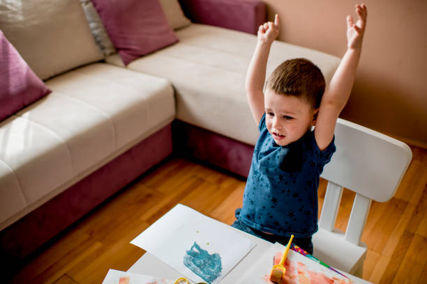istock Cute little boy coloring with water colors 1240332229