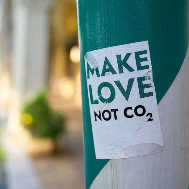 make love not co2 Sticker on a pillar in downtown Berlin with the inscription make love not co2 climate justice photos stock pictures, royalty-free photos & images