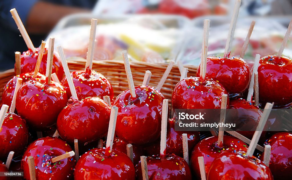 Red toffee apples heap of appetizing red toffee apples outdoors Apple - Fruit Stock Photo