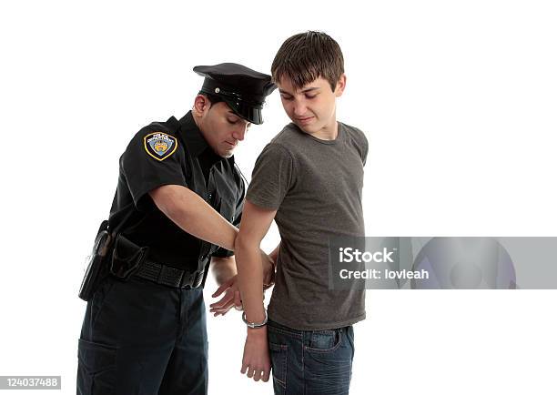 Policeman Handcuffing Teenager Stock Photo - Download Image Now - Child, Police Force, Arrest