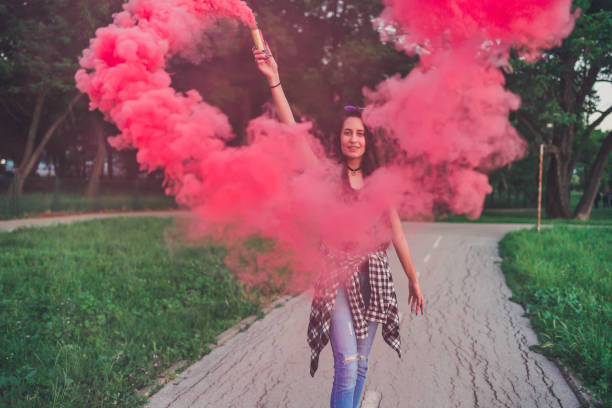 istock Young woman with a torch in the park 1240379713