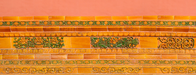 Colorful decorative tiles, old decorations on the wall of a building in the forbidden city.