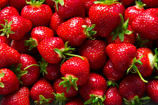 Ripe strawberries with stems, berry pattern. Selective focus.