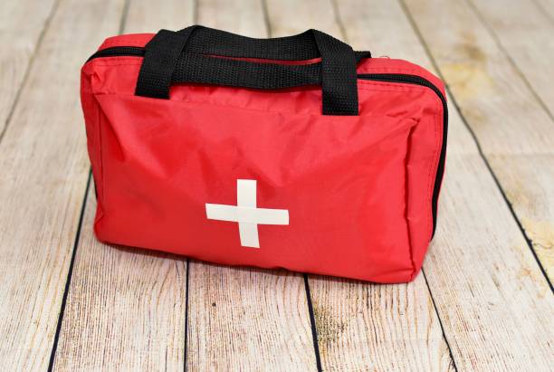 First aid supplies emergency kit for at home and travel response to accidents and emergencies Red first aid bag ready for trauma use during disasters and incidents as first responders first aid photos stock pictures, royalty-free photos & images