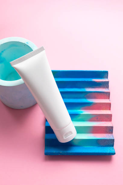 istock White moisturizer cream tube on abstract concrete decor on cute pink background and copy space for text. Mockup hand moisturizer, shampoo or facial cleanser container 1240428502