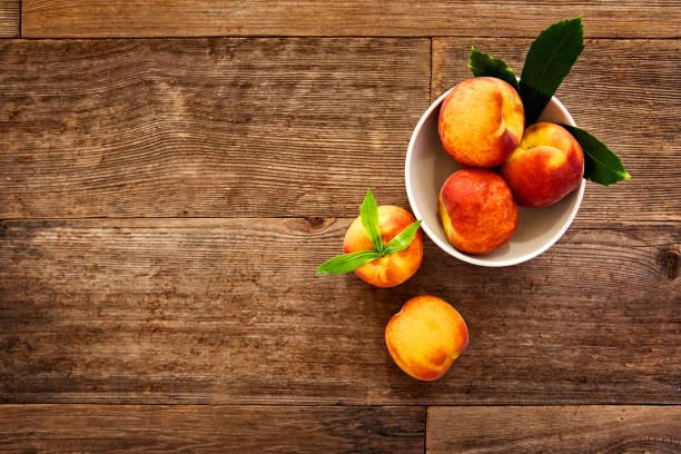This is a photograph of Peaches on Retro wood Picnic Bench