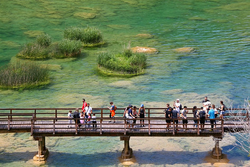 Krka, Croatia - May 23, 2020: Tourists on a bridge, sightseeing in National Park Krka, Croatia. Aerial view.
