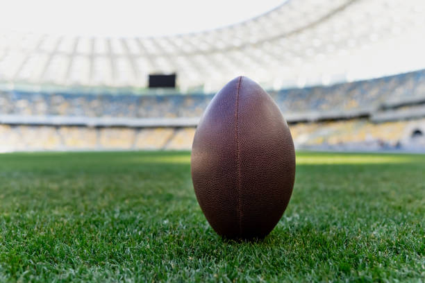 istock rugby ball on green grass at stadium with copy space 1240469167