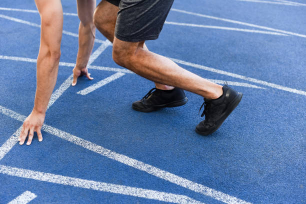 istock cropped view of runner in start position on running track at stadium 1240469200