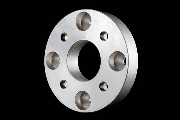 flange (machine part) 3D isometric view Turned, milled and drilled metal machine part (flange), with symmetrical hole pattern, designed for torque transmission, isolated on black background. flange stock pictures, royalty-free photos & images