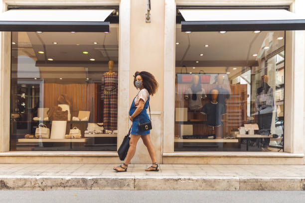 istock Woman shopping protecting herself wearing protective mask 1240471804