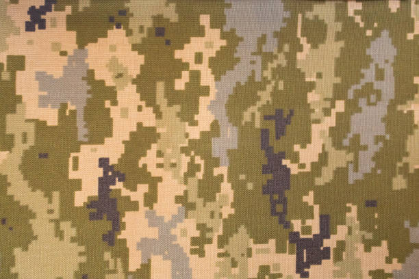 istock Green pixel camouflage military pattern on textile background 1240495668